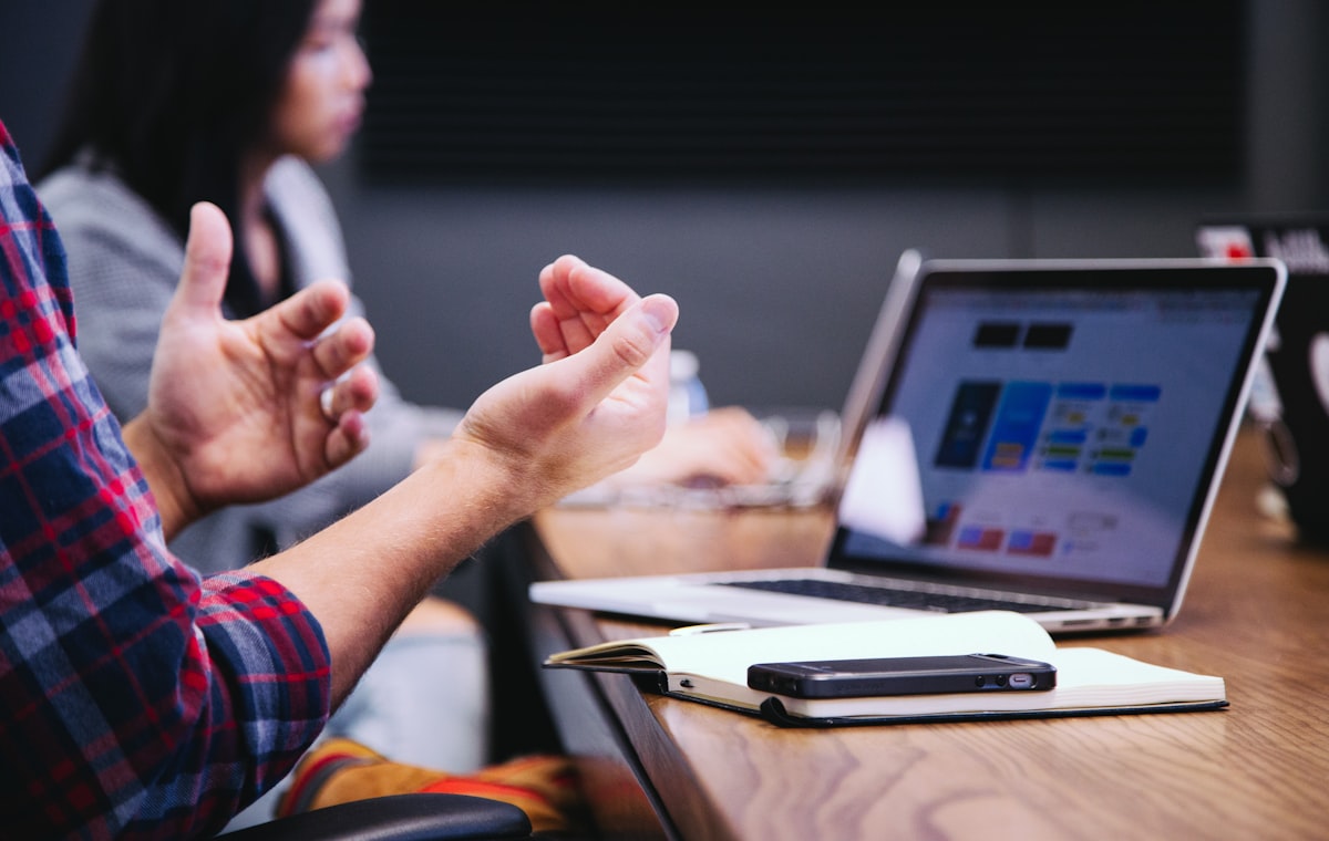 Professionals shaking hands across a conference table